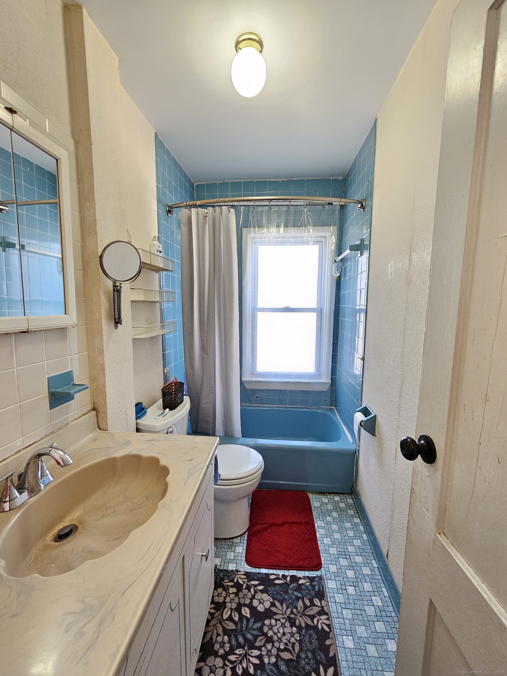42 Washington Street Wallingford, CT 06492 - Photo 12 of 15 a bathroom with a tub sink and mirror