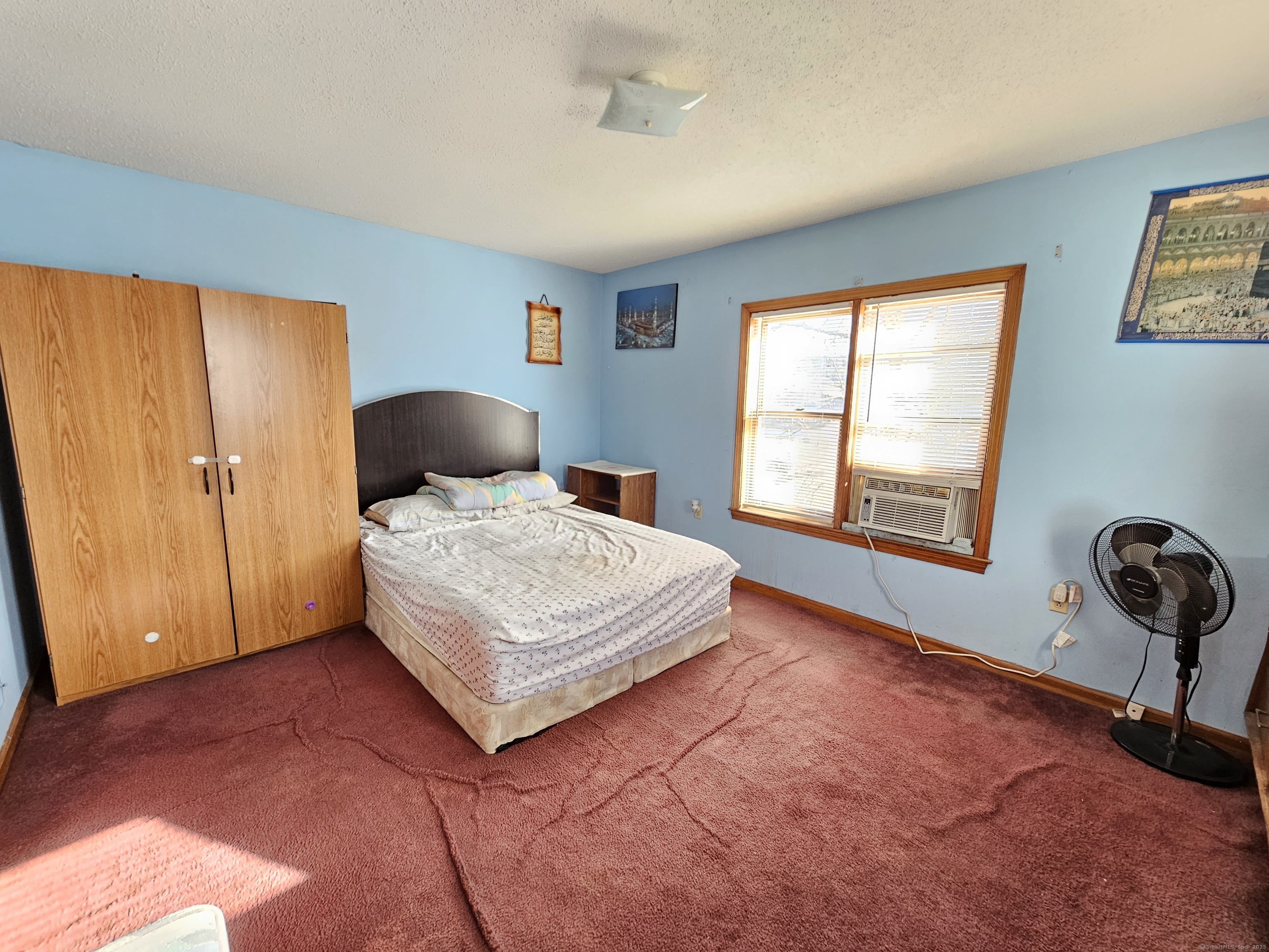 42 Washington Street Wallingford, CT 06492 - Photo 4 of 15 a bedroom with a bed and window with chair