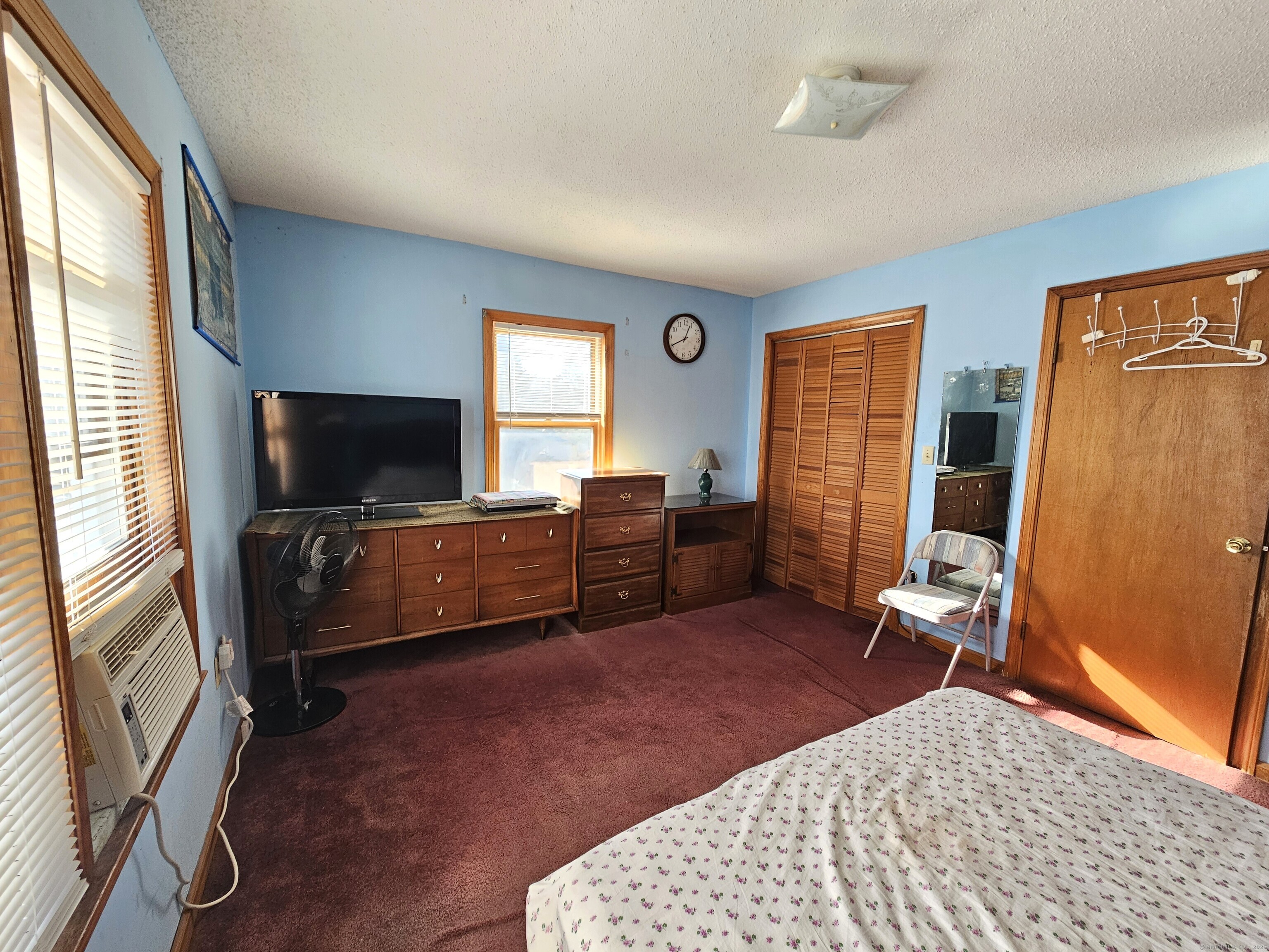 42 Washington Street Wallingford, CT 06492 - Photo 5 of 15 a bedroom with furniture and a flat screen tv