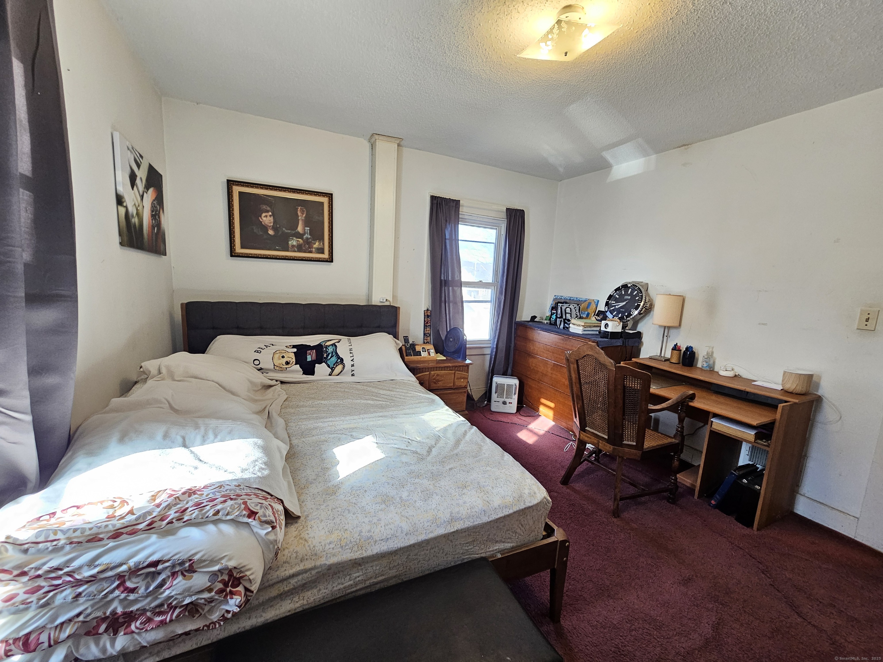 42 Washington Street Wallingford, CT 06492 - Photo 7 of 15 a bedroom with a bed and a table in it