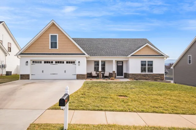 a view of house with swimming pool and porch