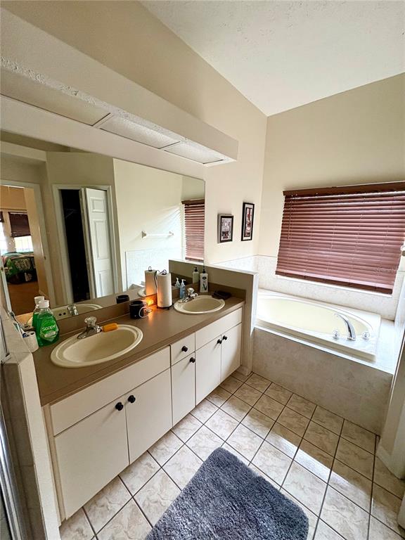 7964 Roundelay Drive New Port Richey, FL 34654 - Photo 18 of 27 a spacious bathroom with a granite countertop sink and a mirror
