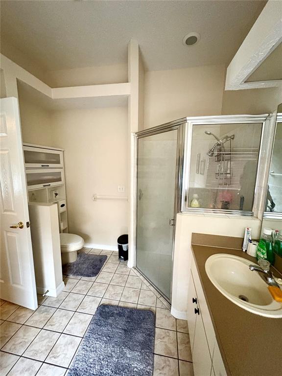 7964 Roundelay Drive New Port Richey, FL 34654 - Photo 19 of 27 a bathroom with a sink a toilet a mirror and shower