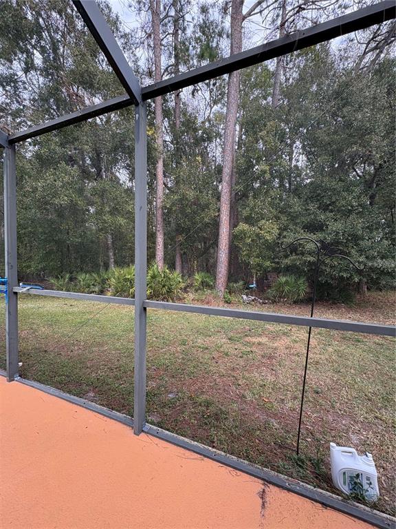 7964 Roundelay Drive New Port Richey, FL 34654 - Photo 24 of 27 a view of a room with a large window and tree