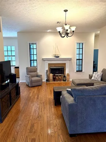 a living room with fireplace furniture and a flat screen tv