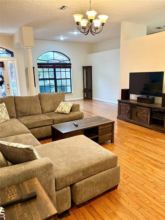 7964 Roundelay Drive New Port Richey, FL 34654 - Photo 5 of 27 a living room with furniture and a flat screen tv