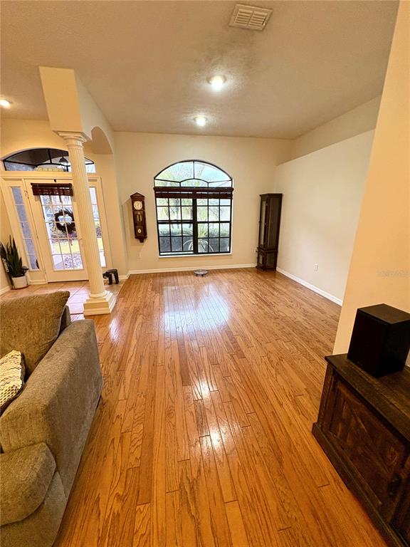 7964 Roundelay Drive New Port Richey, FL 34654 - Photo 7 of 27 a living room with a couch and a wooden floor