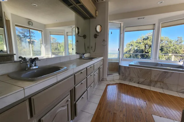 a kitchen with stainless steel appliances granite countertop a sink and a refrigerator