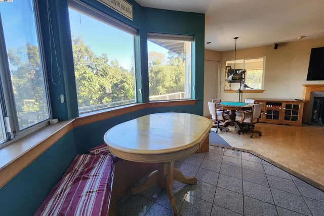 a living room with stainless steel appliances kitchen island granite countertop furniture a rug and a window