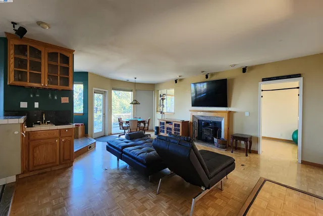 a blue kitchen with a stove a dining table and chairs
