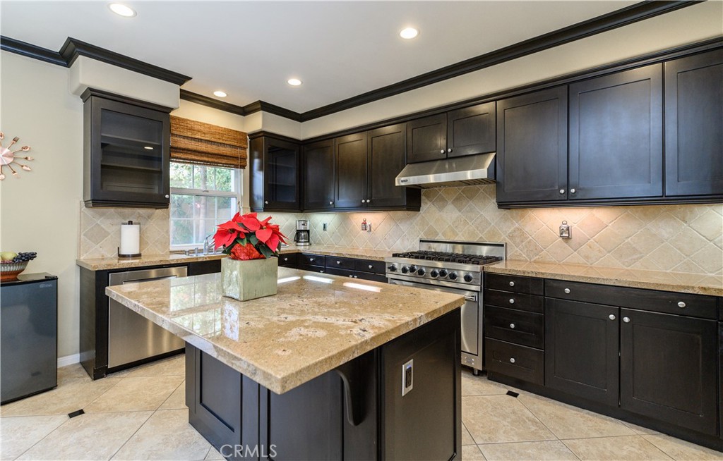 6 Inglenook Irvine, CA 92602 - Photo 18 of 59 a kitchen with stainless steel appliances granite countertop a sink stove and cabinets
