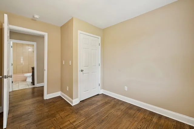 a bathroom with a granite countertop sink a toilet and a mirror