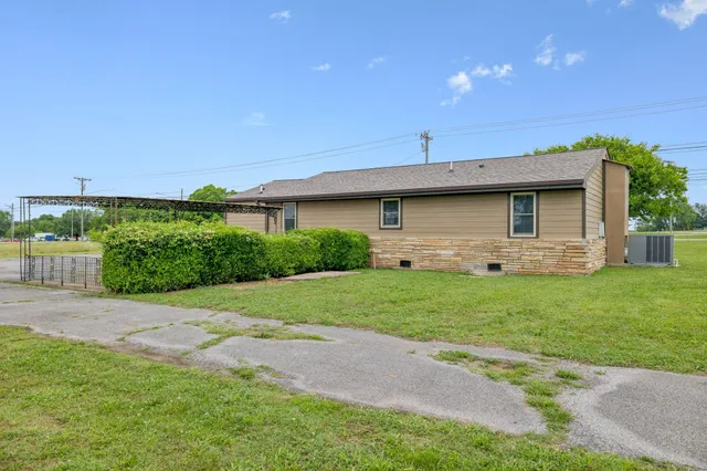 an aerial view of a house with a yard basket ball court and outdoor seating