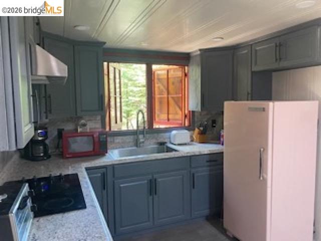 26591 Snow Bowl Road Long Barn, CA 95335 - Photo 14 of 38 a kitchen with a sink a stove and refrigerator