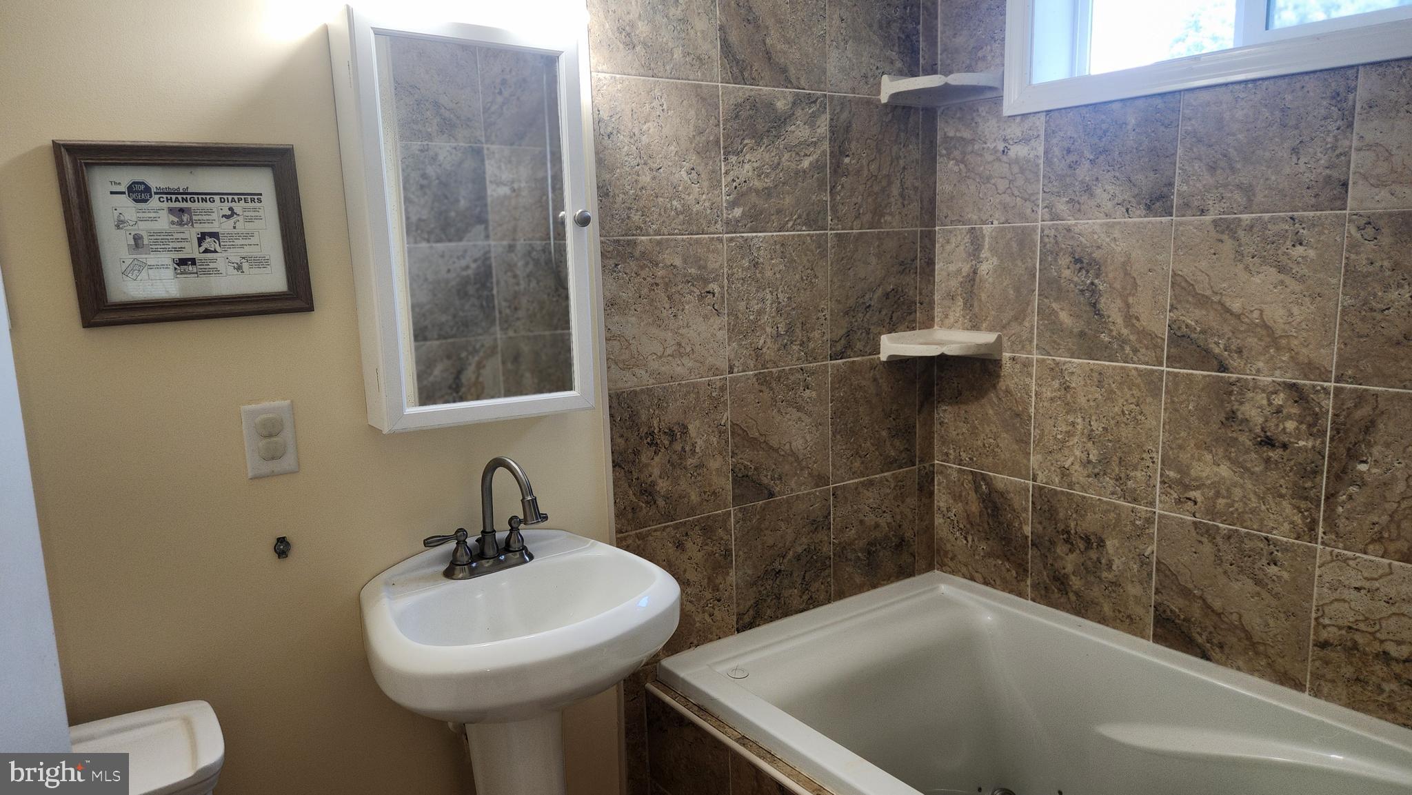 18601 Johnson Road Lincoln, DE 19960 - Photo 13 of 15 a bathroom with a sink toilet and shower
