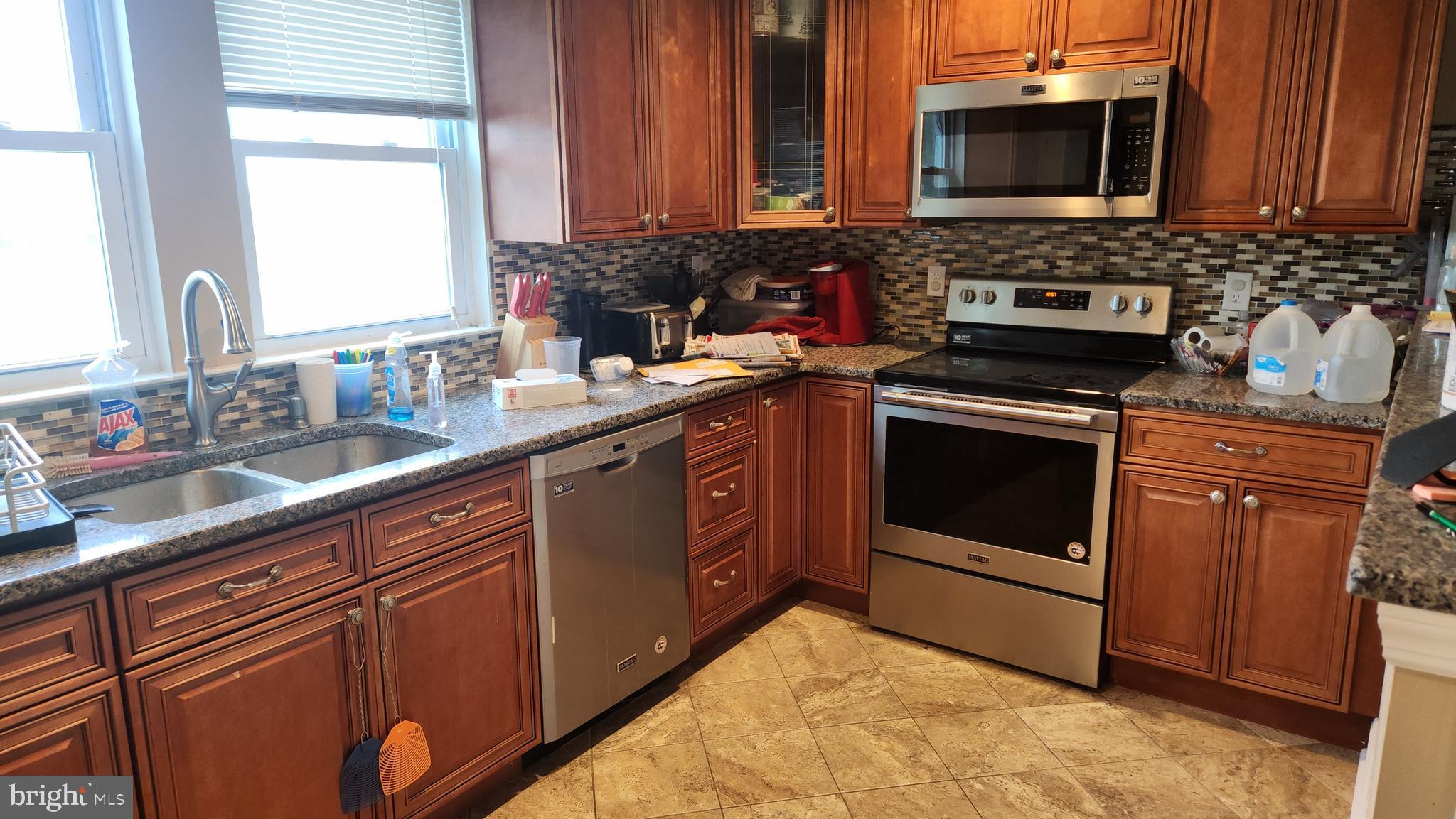18601 Johnson Road Lincoln, DE 19960 - Photo 4 of 8 a kitchen with stainless steel appliances granite countertop a sink stove and microwave