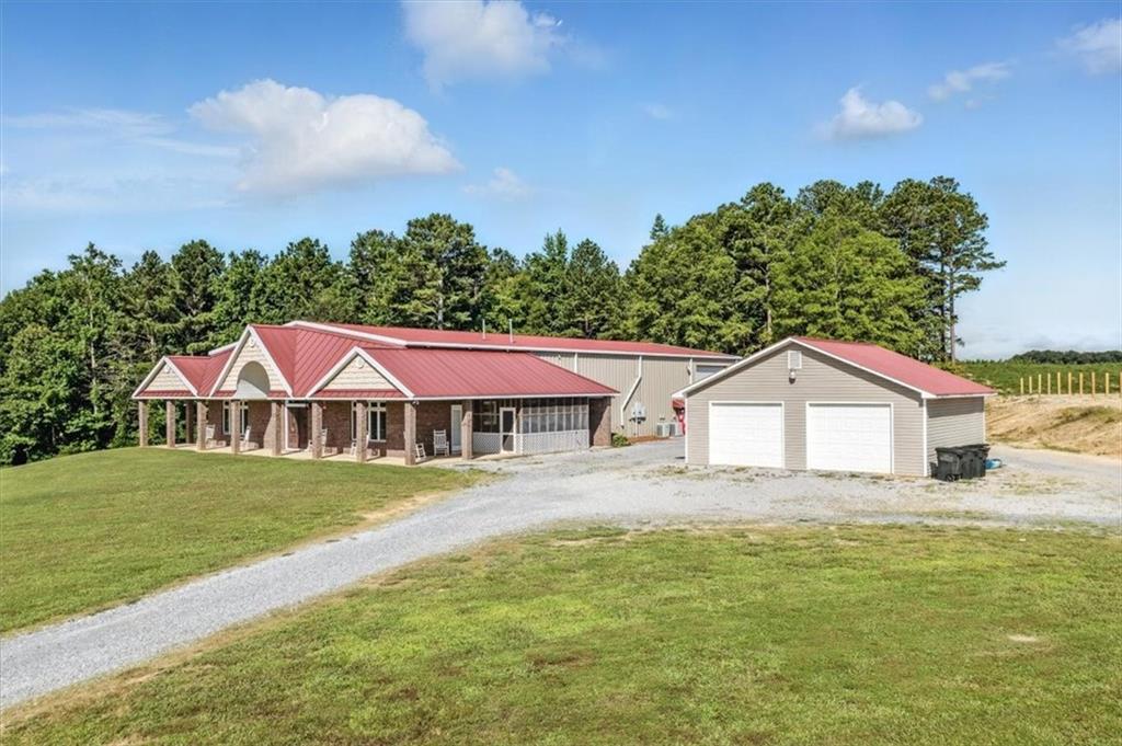 231 Gordon Road Cedartown, GA 30125 - Photo 1 of 49 a view of a yard with a house in the background