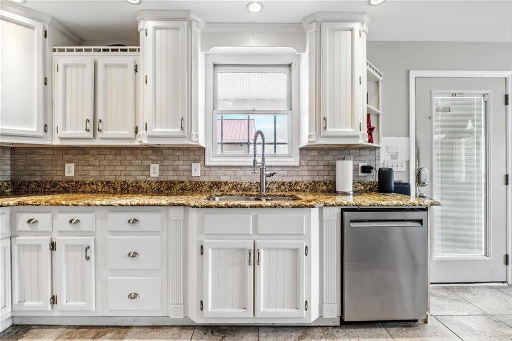 231 Gordon Road Cedartown, GA 30125 - Photo 12 of 49 a kitchen with granite countertop white cabinets and sink