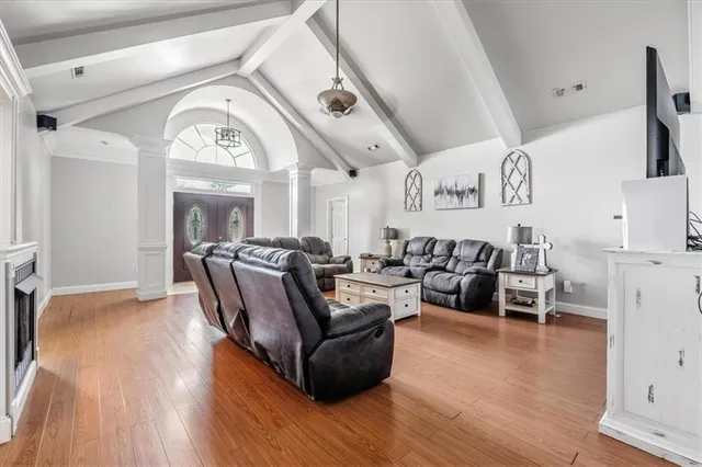 a living room with furniture and wooden floor