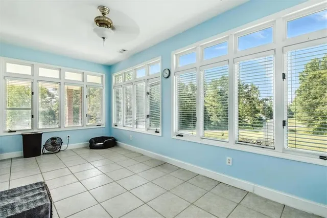 a spacious bedroom with a bed and a large window