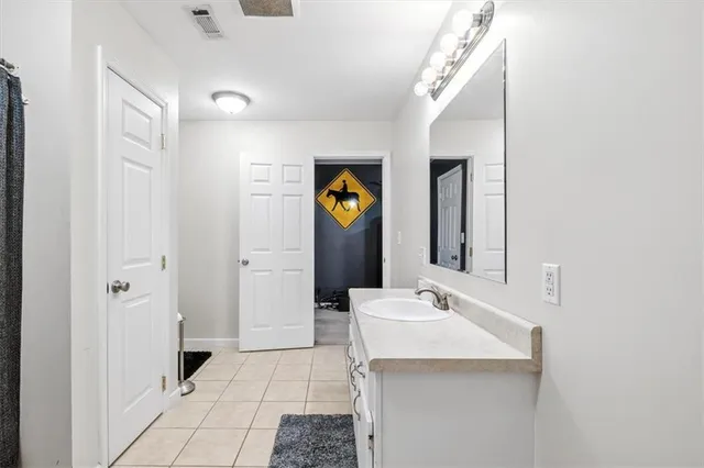 a bathroom with a sink and mirror
