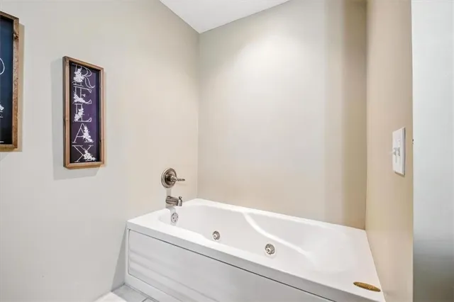 a bathroom with a bathtub and a sink