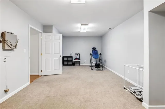 an empty room with furniture and a window