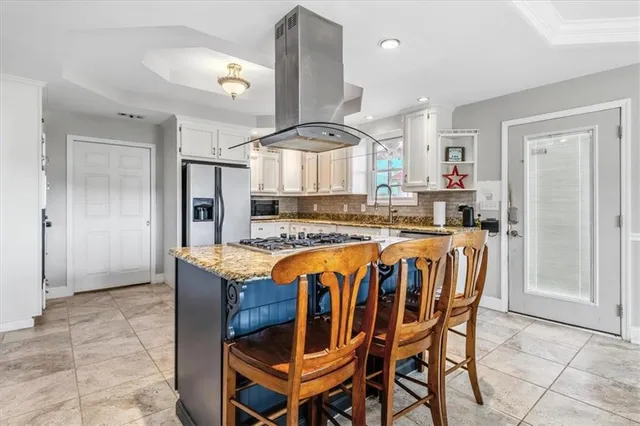 a large kitchen with a table and chairs