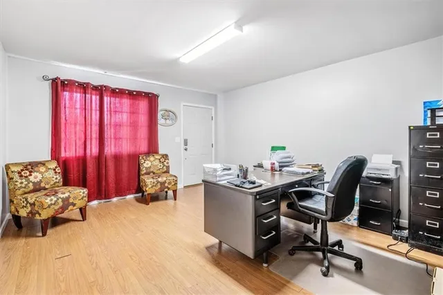 a view of a workspace with furniture and a window