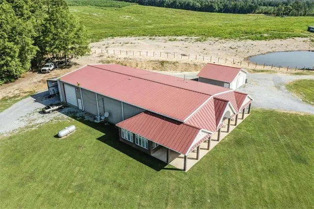 a backyard of a house with lots of green space and fountain