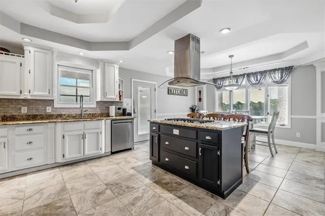 a kitchen with a stove a sink and a refrigerator