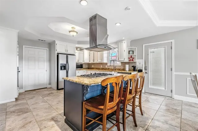 a large kitchen with a table and chairs