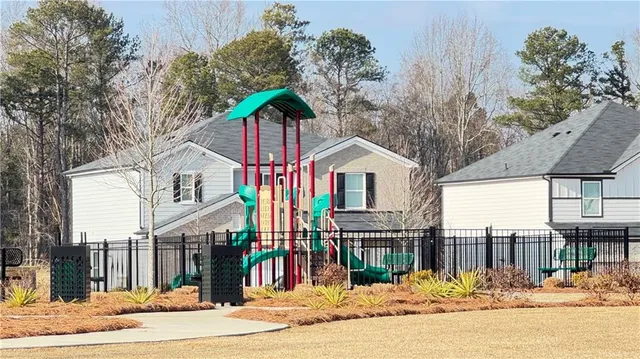 a view of residential houses with outdoor space and ocean view