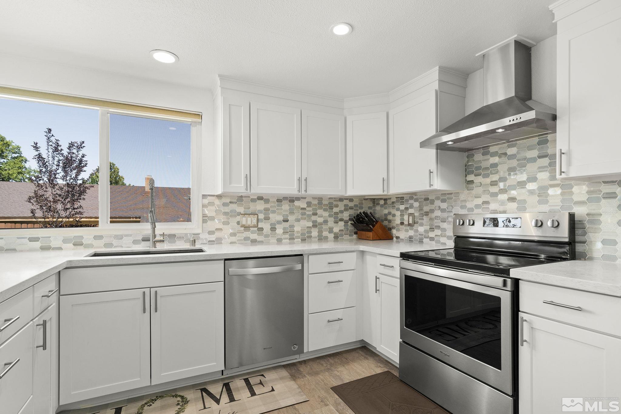 915 Pinebrook Road Reno, NV 89509 - Photo 13 of 29 a kitchen with white cabinets and appliances