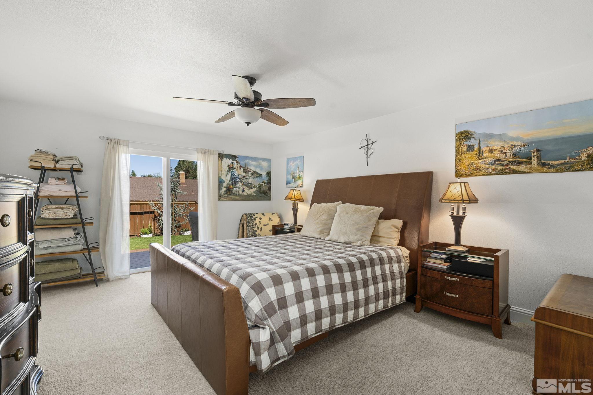 915 Pinebrook Road Reno, NV 89509 - Photo 14 of 29 a bedroom with a bed a dresser and a book shelf