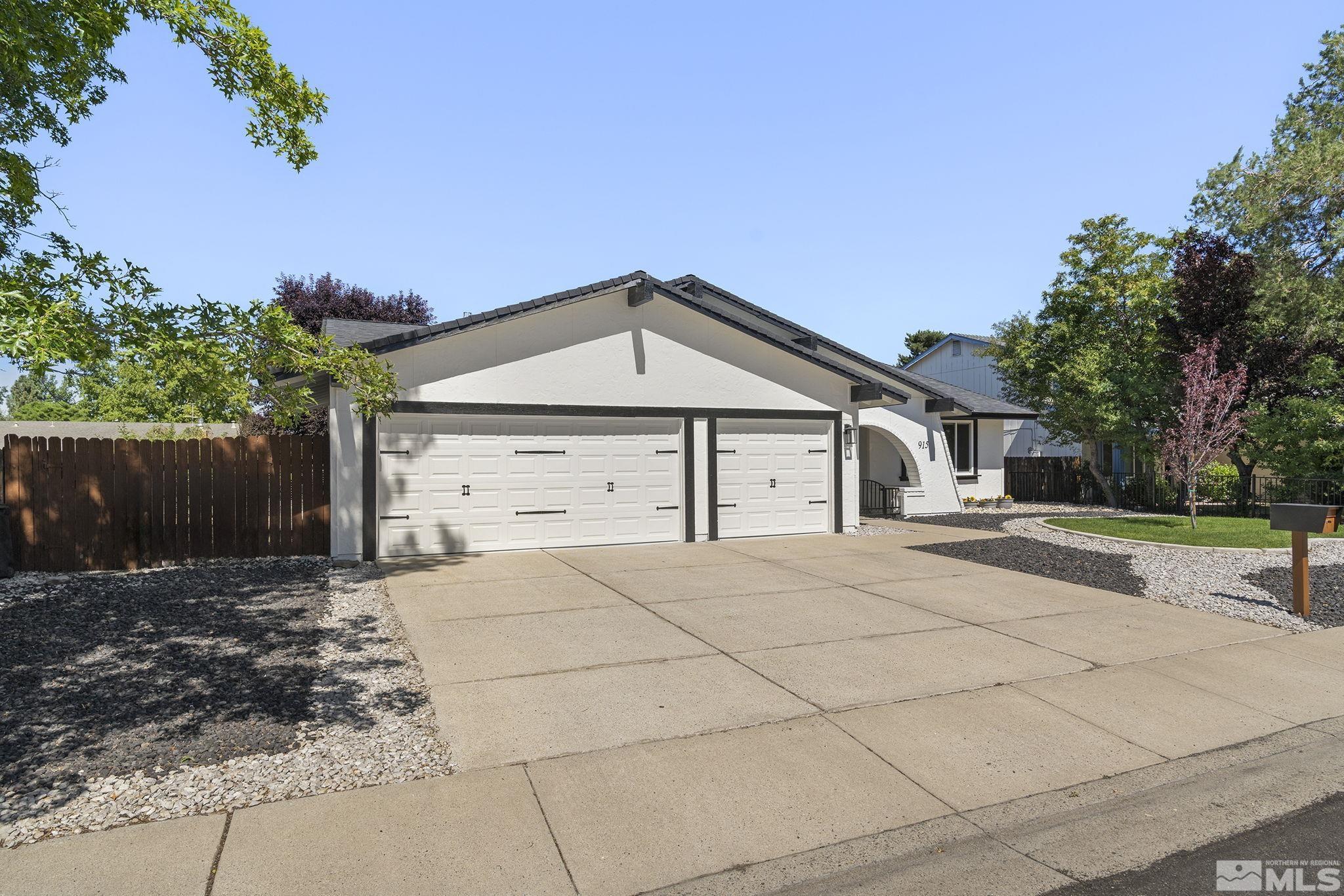 915 Pinebrook Road Reno, NV 89509 - Photo 3 of 29 a front view of a house with a yard and garage
