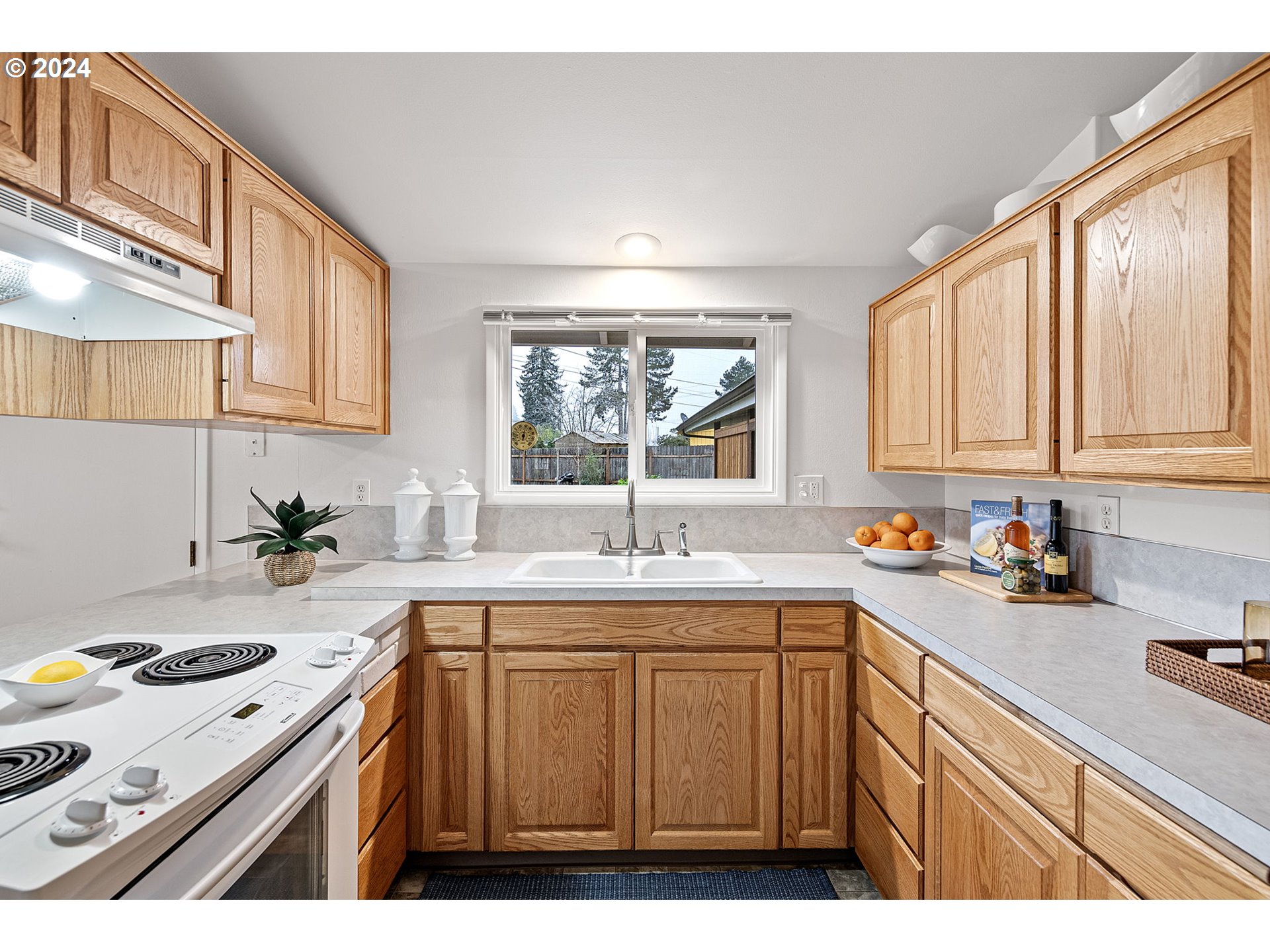 494 Winston Place Springfield, OR 97477 - Photo 15 of 48 a kitchen that has a sink and a stove in it