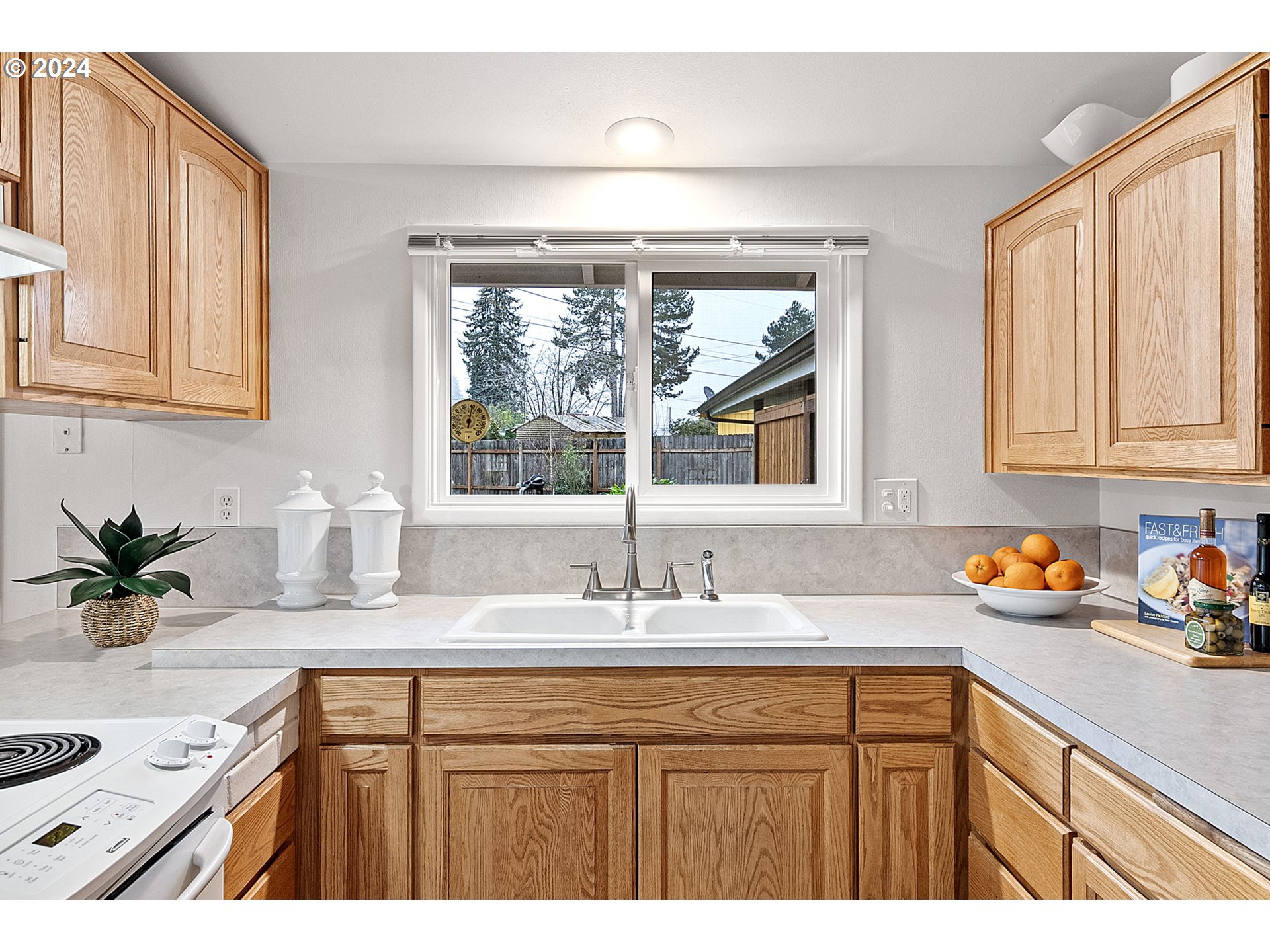 494 Winston Place Springfield, OR 97477 - Photo 16 of 48 a kitchen with sink a window and cabinets