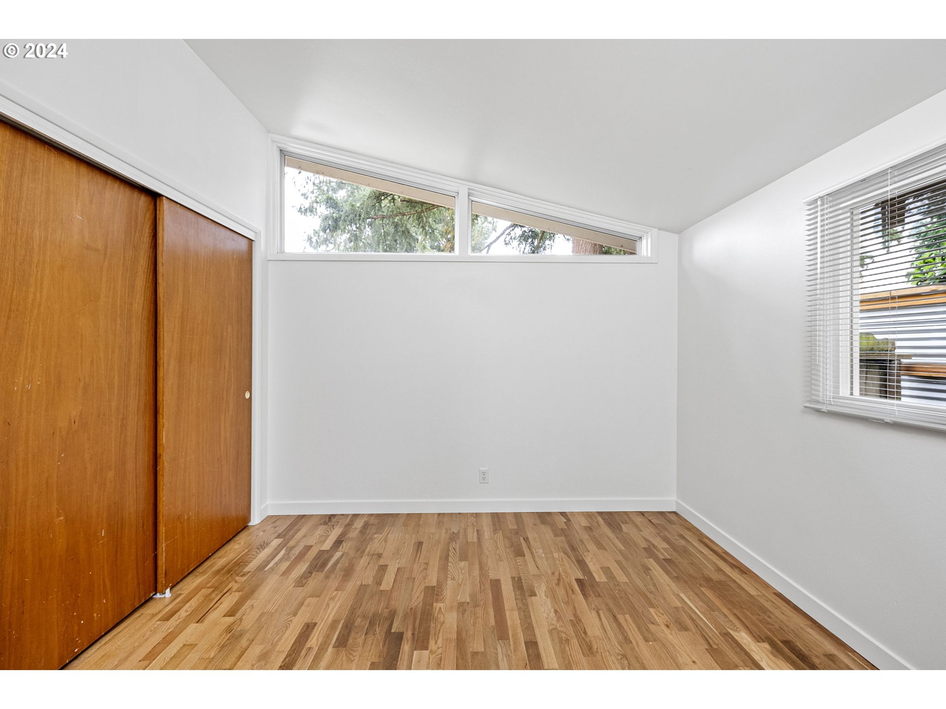 494 Winston Place Springfield, OR 97477 - Photo 32 of 48 a view of an empty room with wooden floor and a window