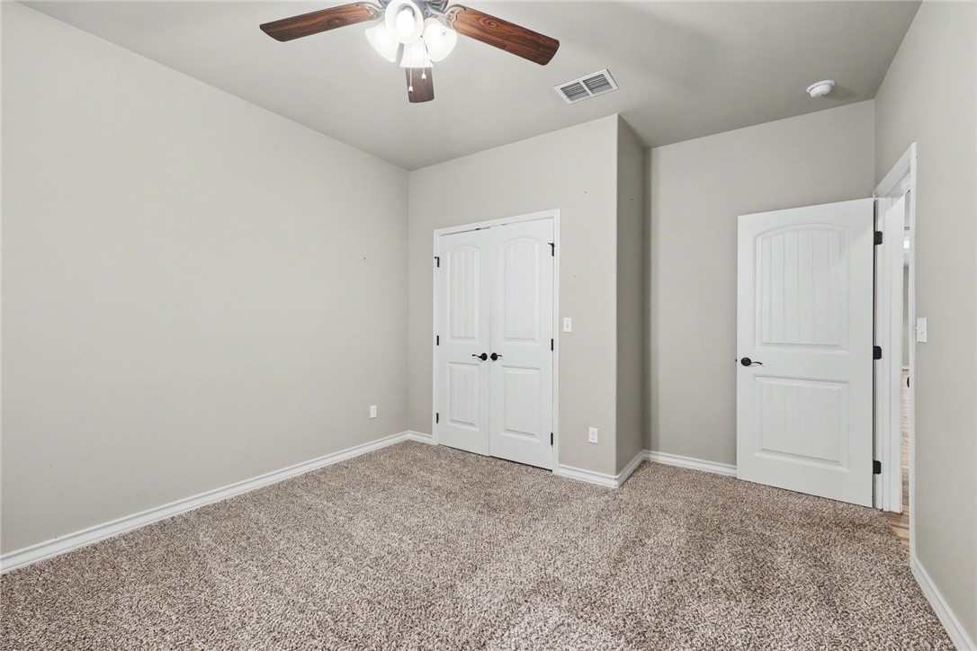 302 Cooper Road, Unit E2 Odem, TX 78370 - Photo 15 of 24 an empty room with chandelier fan
