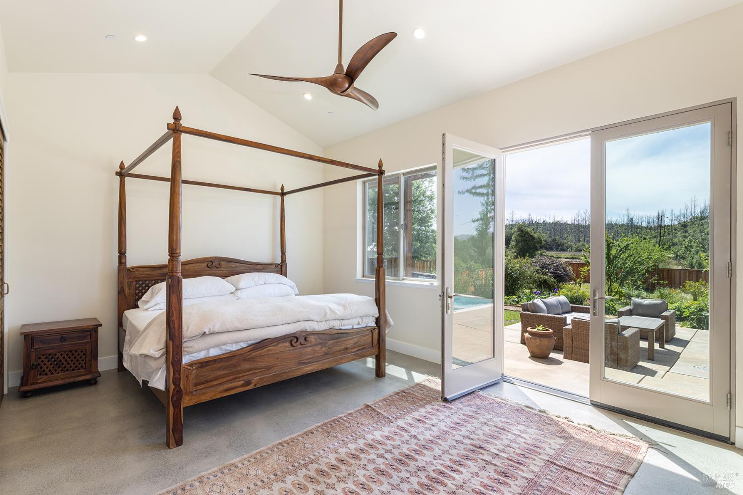 753 Sunnyside Road St. Helena, CA 94574 - Photo 27 of 55 a bedroom with a bed lamp and a large window