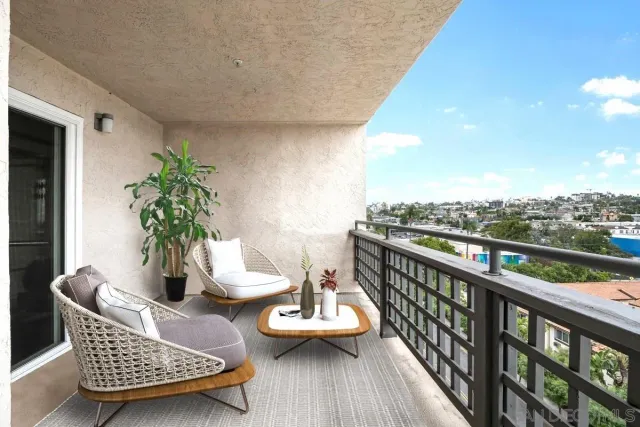 a balcony with furniture and wooden floor