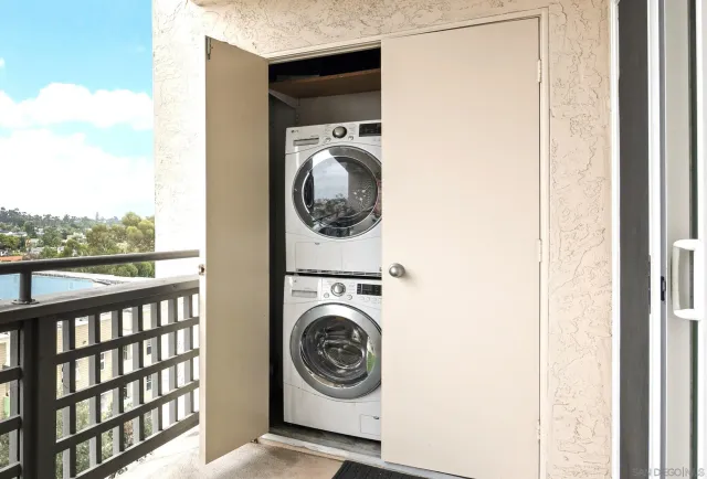 a view of a bedroom with washer and dryer