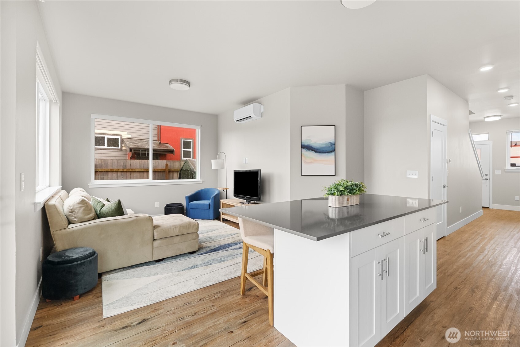 1884 Front Street, Unit A Lynden, WA 98264 - Photo 12 of 35 a living room with furniture a large window and a wooden floor