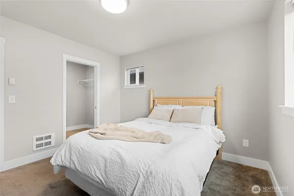 a bedroom with a bed and a painting on the wall