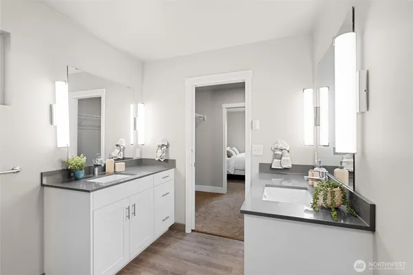 a bathroom with a double vanity sink and a mirror