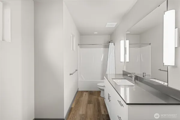 a bathroom with a sink a mirror and a shower