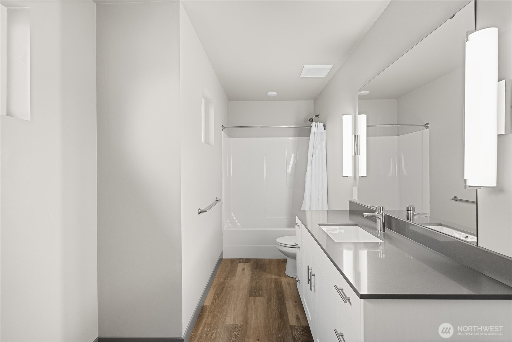 1884 Front Street, Unit A Lynden, WA 98264 - Photo 25 of 35 a bathroom with a sink a mirror and a shower