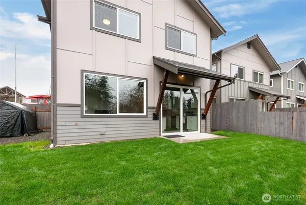 a view of a house with a yard and sitting area