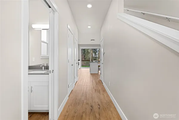a view of a hallway with wooden floor